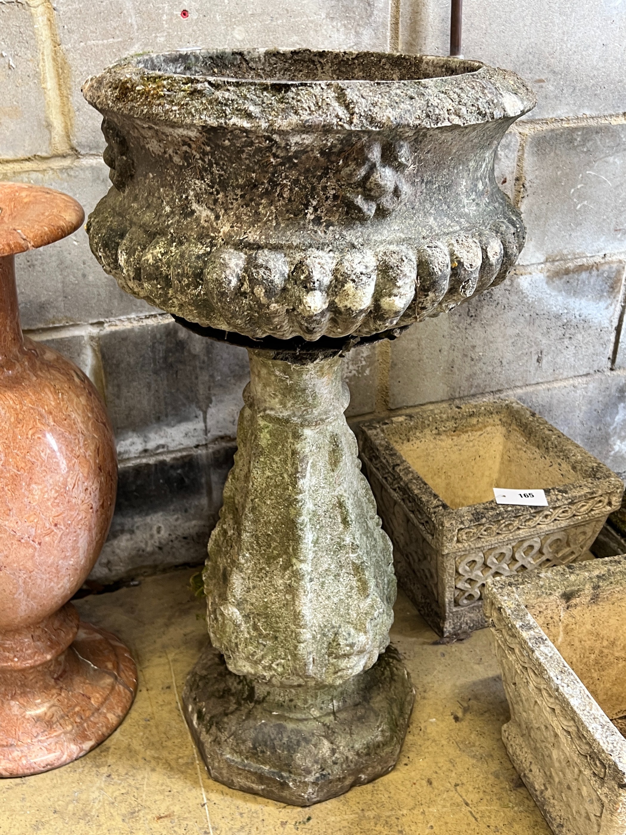 A reconstituted stone circular garden fountain, diameter 43cm, height 84cm